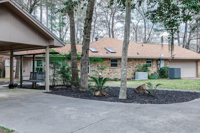 view of front of house with central AC and a garage