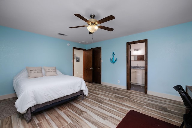 bedroom featuring sink, connected bathroom, and ceiling fan