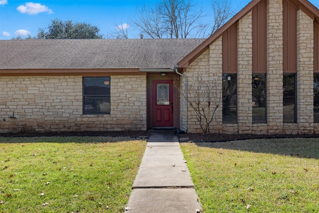 doorway to property with a lawn