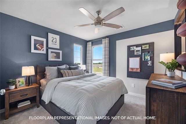 bedroom featuring ceiling fan and carpet