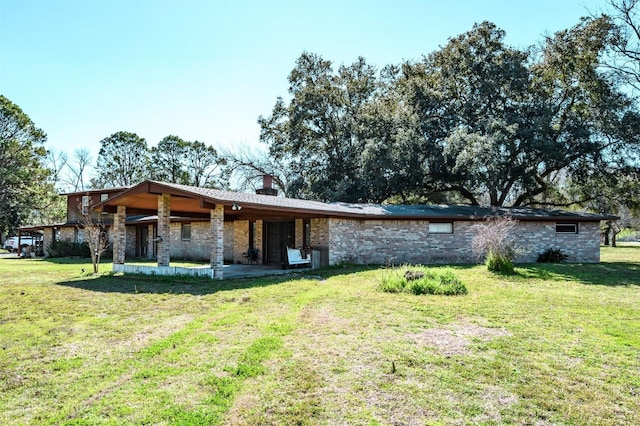 view of front of property with a patio area and a front lawn