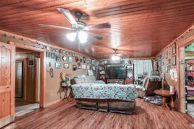 800 Oak St, Anahuac, TX 77514 - bedroom with wooden ceiling, wood finished floors, and baseboards