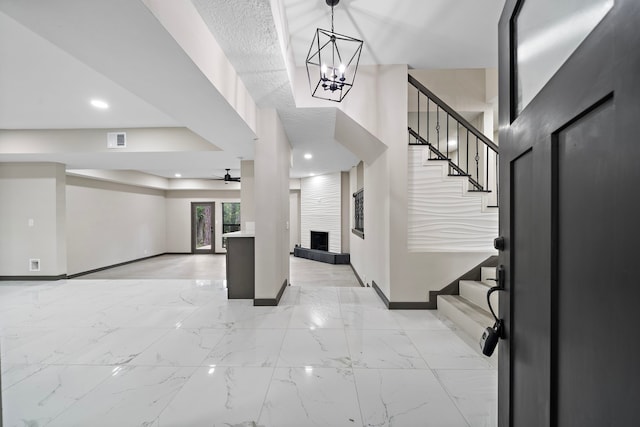 entryway featuring ceiling fan and a fireplace