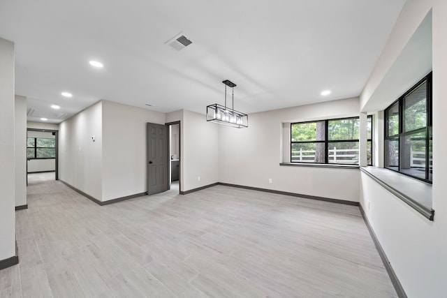 unfurnished dining area with a healthy amount of sunlight and light hardwood / wood-style floors