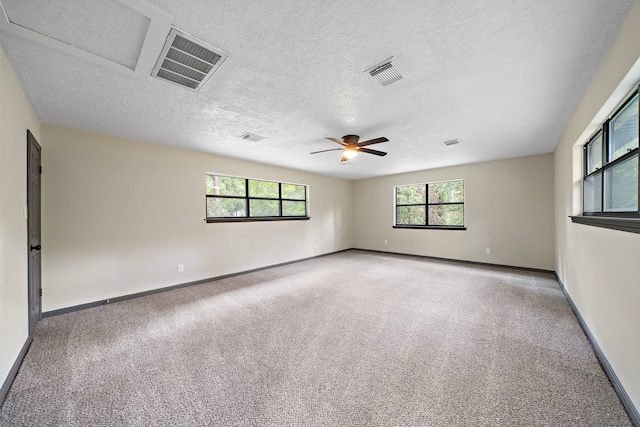 unfurnished room with ceiling fan, a textured ceiling, and carpet