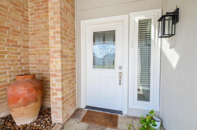 property entrance with brick siding