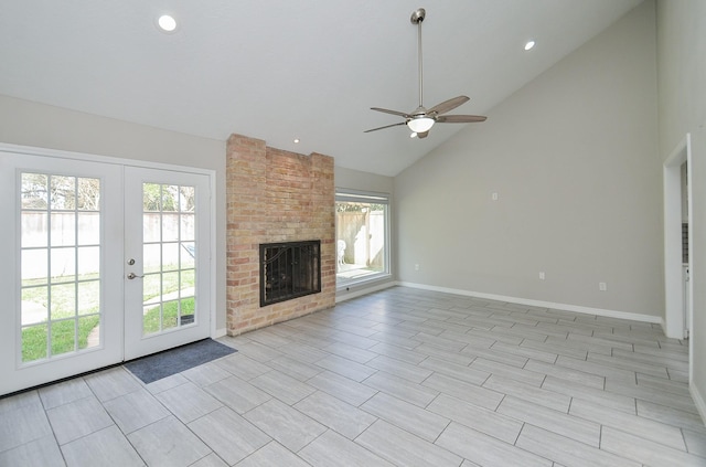 unfurnished living room featuring french doors, a brick fireplace, ceiling fan, high vaulted ceiling, and baseboards