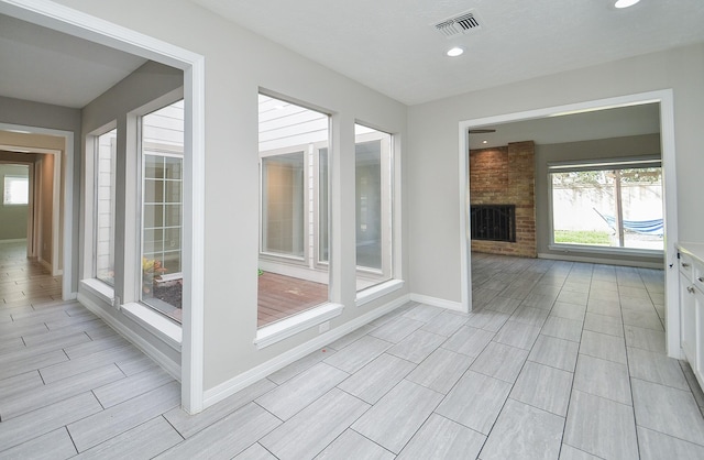 interior space with baseboards, visible vents, a wealth of natural light, and recessed lighting