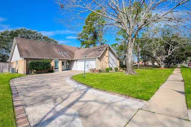 view of front facade featuring brick siding, central air condition unit, concrete driveway, an attached garage, and a front yard