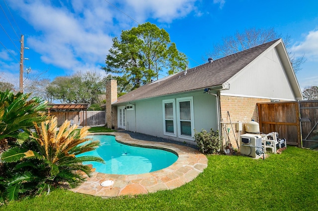 view of pool with a fenced in pool, a yard, and fence