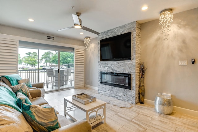 living room featuring ceiling fan and a fireplace