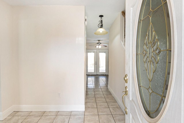 hall with french doors and light tile patterned floors