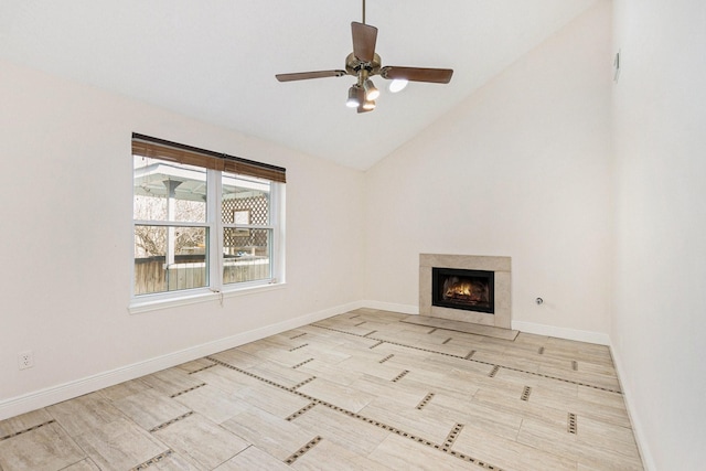 unfurnished living room featuring vaulted ceiling, ceiling fan, a fireplace, and light wood-type flooring