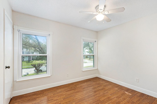 unfurnished room with ceiling fan, hardwood / wood-style floors, and a textured ceiling