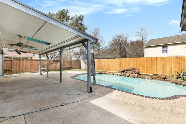 view of swimming pool with ceiling fan and a patio area