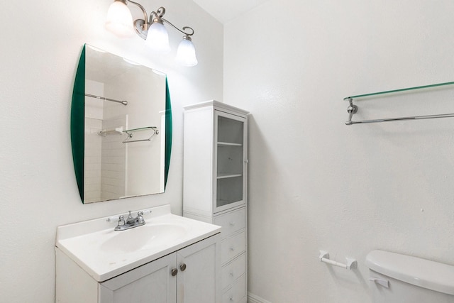 bathroom featuring vanity, toilet, and a shower