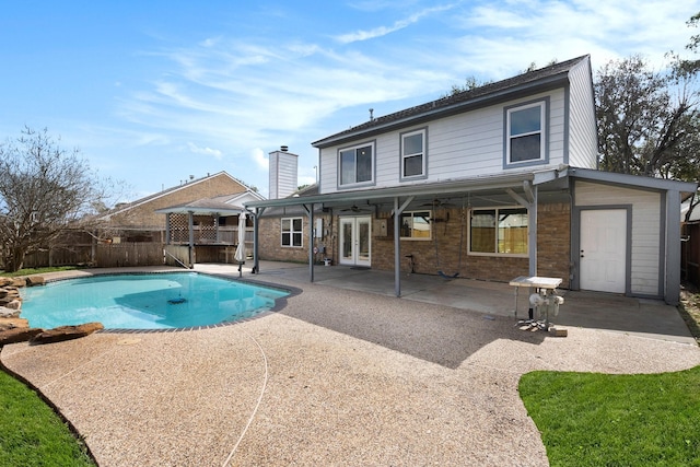 view of swimming pool with a patio area, french doors, and ceiling fan