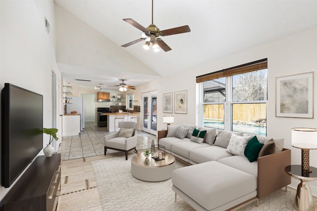 living room featuring high vaulted ceiling and ceiling fan