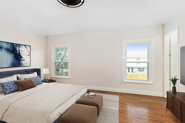 bedroom with dark hardwood / wood-style flooring