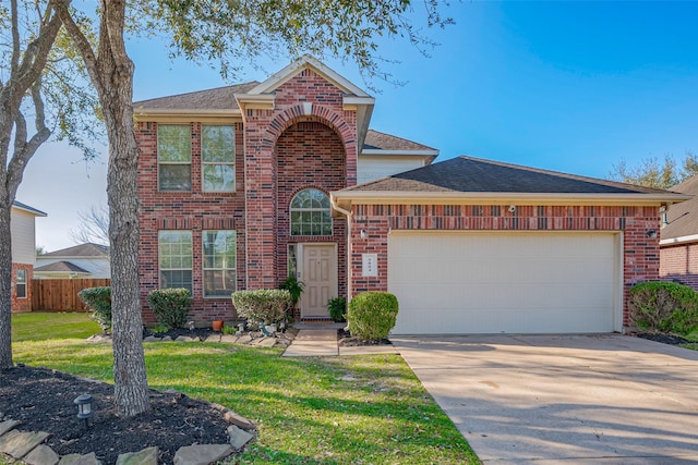 traditional home featuring a front lawn, fence, concrete driveway, an attached garage, and brick siding