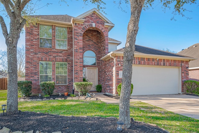 traditional-style home with concrete driveway, an attached garage, fence, and brick siding