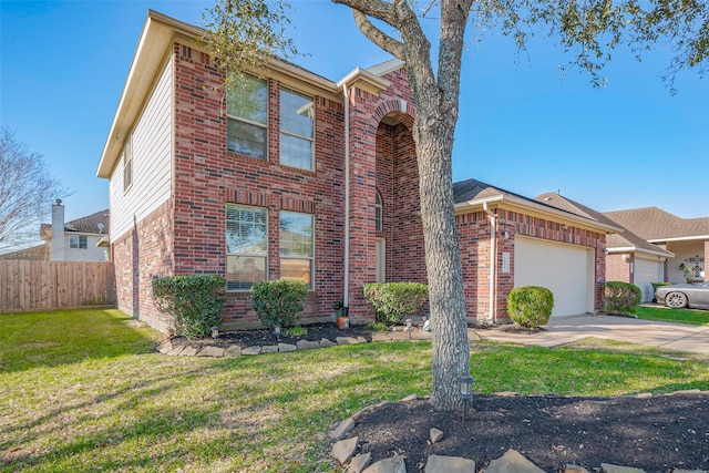 traditional-style home featuring a front yard, fence, driveway, an attached garage, and brick siding