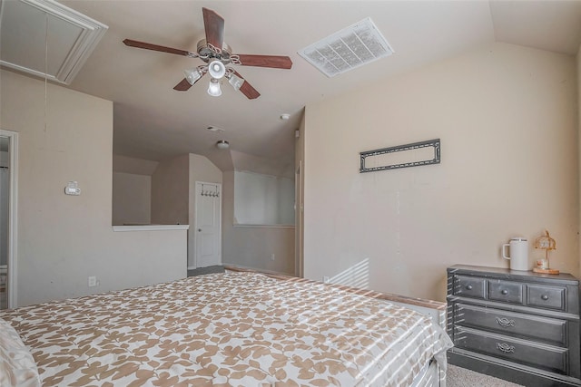 bedroom featuring attic access, visible vents, lofted ceiling, and ceiling fan