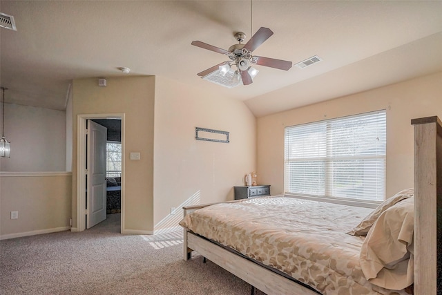 carpeted bedroom with vaulted ceiling, baseboards, visible vents, and ceiling fan