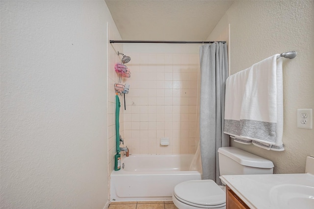 full bath with tile patterned flooring, toilet, vanity, a textured wall, and a textured ceiling