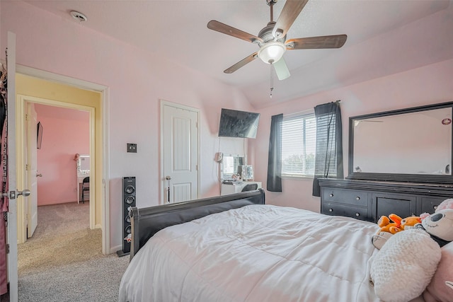 bedroom featuring light colored carpet, a ceiling fan, and vaulted ceiling