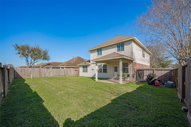 back of house featuring a patio area, a fenced backyard, and a yard