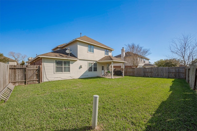 back of property with a patio, a lawn, and a fenced backyard