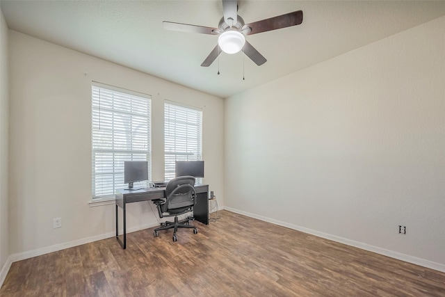 office featuring a ceiling fan, baseboards, and wood finished floors