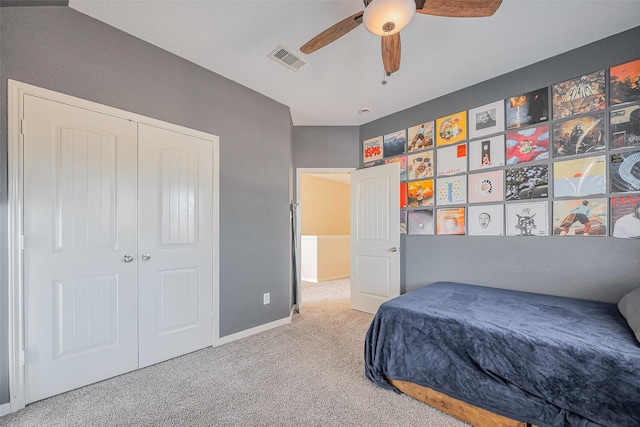 carpeted bedroom featuring visible vents, baseboards, a closet, and a ceiling fan