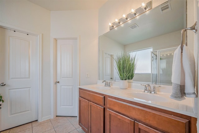 bathroom featuring tile patterned flooring, visible vents, and a sink