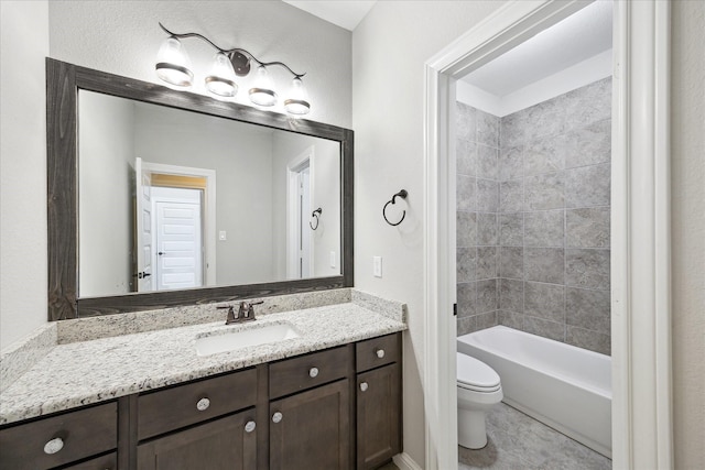 full bathroom with vanity, toilet, and tiled shower / bath combo
