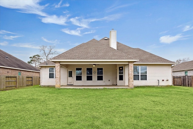 rear view of house featuring a yard, ceiling fan, and a patio area