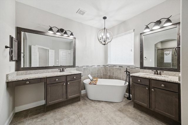 bathroom featuring independent shower and bath, tile walls, tile patterned flooring, vanity, and an inviting chandelier