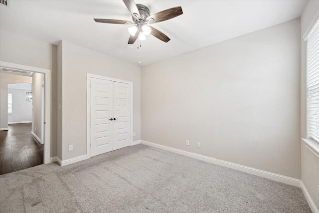 unfurnished bedroom featuring a closet, ceiling fan, and carpet flooring