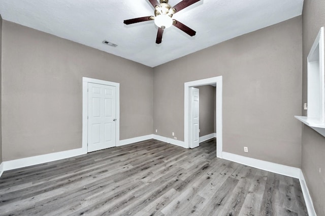 spare room featuring ceiling fan and light hardwood / wood-style floors