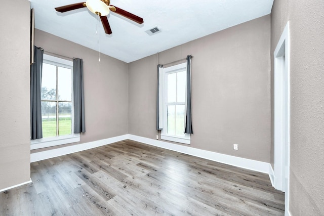 unfurnished room with light hardwood / wood-style flooring and ceiling fan