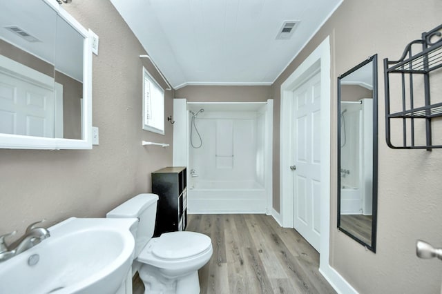 bathroom with toilet, sink, and hardwood / wood-style floors