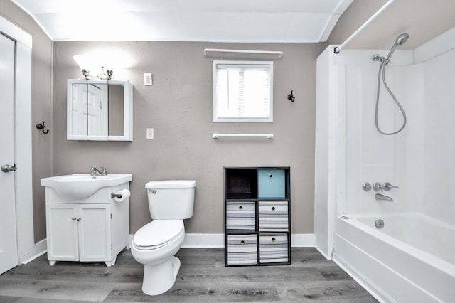 full bathroom with vanity, tub / shower combination, hardwood / wood-style floors, and toilet