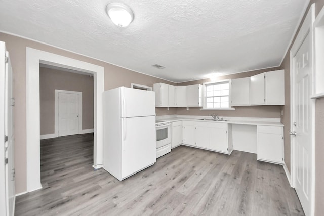 kitchen with white cabinetry, sink, white appliances, and light hardwood / wood-style flooring