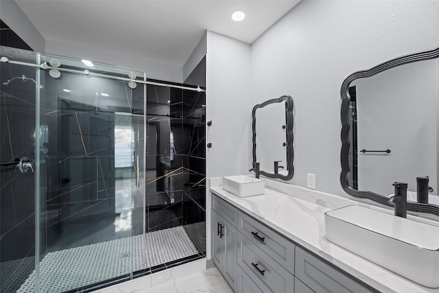 bathroom with vanity and a shower with door