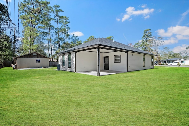 back of property featuring a yard and a patio