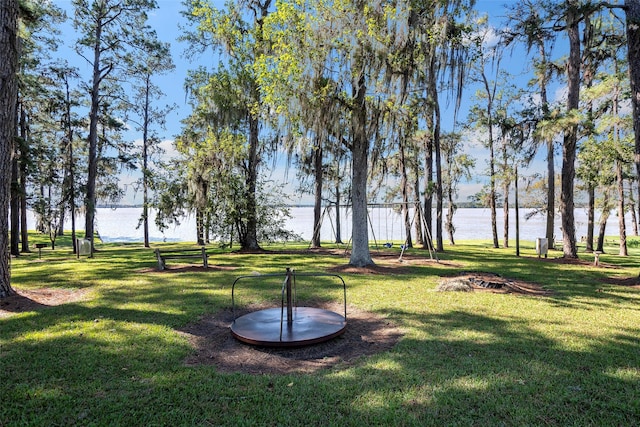 view of home's community featuring a water view and a lawn