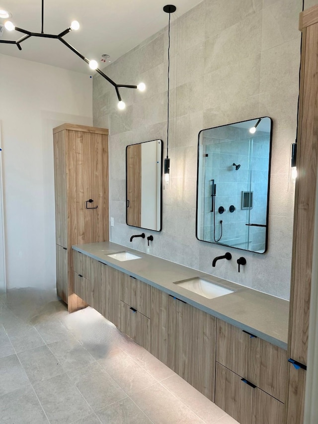 bathroom with tile patterned floors, vanity, and tile walls