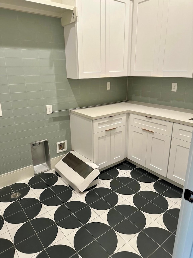 clothes washing area featuring cabinets, washer hookup, and tile patterned flooring