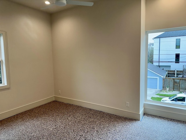 spare room featuring ceiling fan and carpet flooring